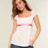 Enkel babydoll-top i satin med knytband Enkel babydoll-top i satin med knytband