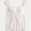 Enkel babydoll-top i satin med knytband Enkel babydoll-top i satin med knytband