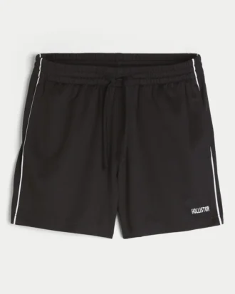 Fotbollsshorts i stickat material med logotyp, längd till mitten av låret