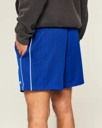 Fotbollsshorts i stickat material med logotyp, längd till mitten av låret
