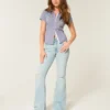 Högmidjade, slitna, ljusblå flare-jeans Högmidjade, slitna, ljusblå flare-jeans