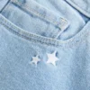 Lågmidjade bootcut-jeans med broderad stjärna Lågmidjade bootcut-jeans med broderad stjärna