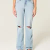 Lågmidjade, ljusblå, slitna, lösa jeans