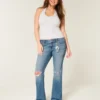 Lågmidjade, slitna bootcut-jeans i medium tvätt