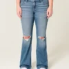Lågmidjade, slitna bootcut-jeans i medium tvätt