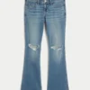 Lågmidjade, slitna bootcut-jeans i medium tvätt