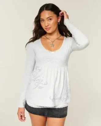 Långärmad babydoll-top med grafiskt tryck och pinch bust