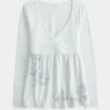 Långärmad babydoll-top med grafiskt tryck och pinch bust Långärmad babydoll-top med grafiskt tryck och pinch bust