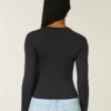 Långärmad sömlös baby-T-shirt i stretchig trikå