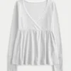 Lätt långärmad babydoll-top i pointelle